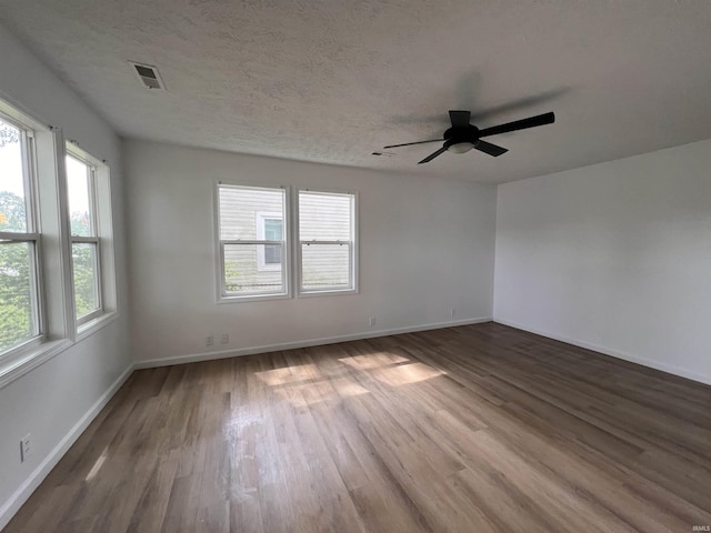 2108 W Memorial Dr, Muncie, IN 47302 - empty room with wood finished floors, ceiling fan, and baseboards