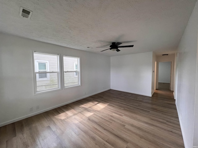 2108 W Memorial Dr, Muncie, IN 47302 - empty room featuring wood finished floors, baseboards, a textured ceiling, and a ceiling fan