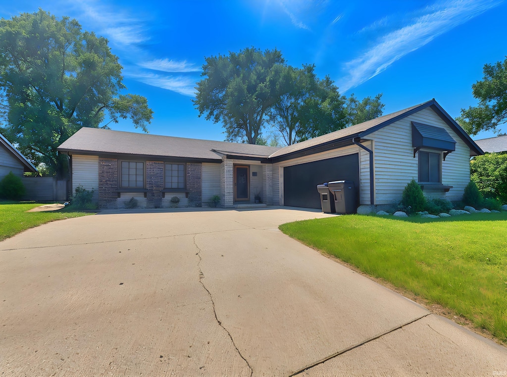 2104 Valdez Dr, Lafayette, IN 47905 - ranch-style home featuring concrete driveway, a front lawn, and a garage