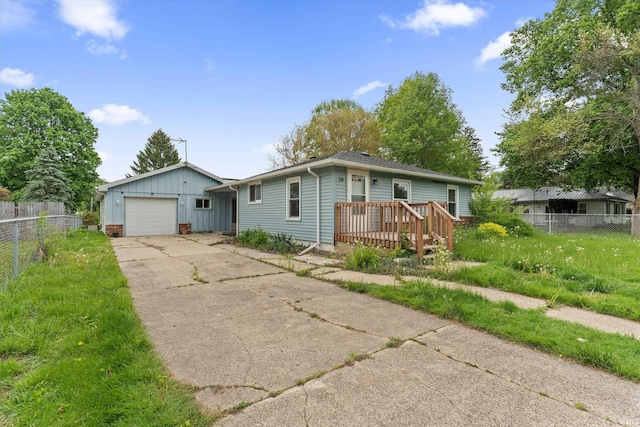114 S Grand St, Lakeville, IN 46536 - single story home with driveway, fence, a deck, and a garage