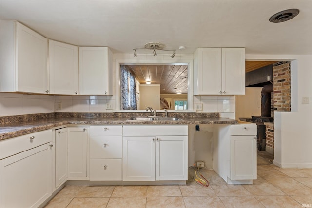 114 S Grand St, Lakeville, IN 46536 - kitchen featuring a sink, white cabinetry, and dark countertops