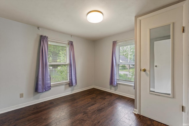 114 S Grand St, Lakeville, IN 46536 - unfurnished room featuring healthy amount of natural light, dark wood-style flooring, and baseboards