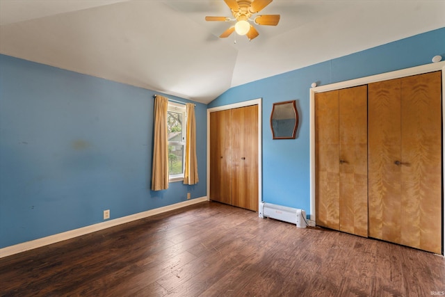 114 S Grand St, Lakeville, IN 46536 - unfurnished bedroom featuring baseboard heating, vaulted ceiling, multiple closets, wood finished floors, and baseboards
