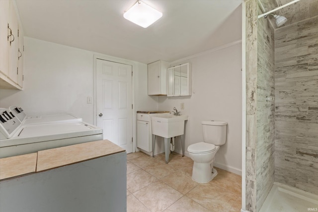 114 S Grand St, Lakeville, IN 46536 - bathroom with washing machine and clothes dryer, a shower stall, toilet, and tile patterned floors