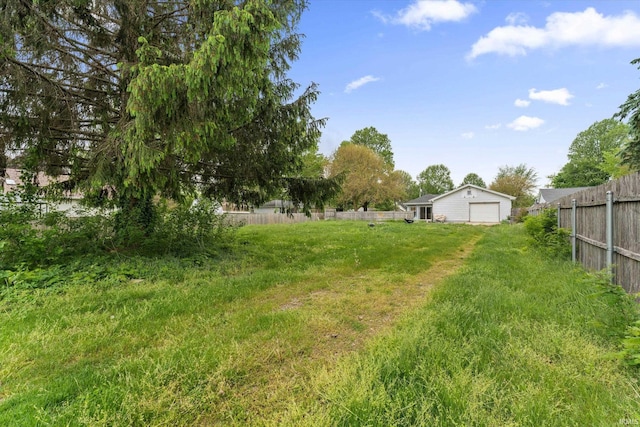 114 S Grand St, Lakeville, IN 46536 - view of yard featuring fence and a detached garage