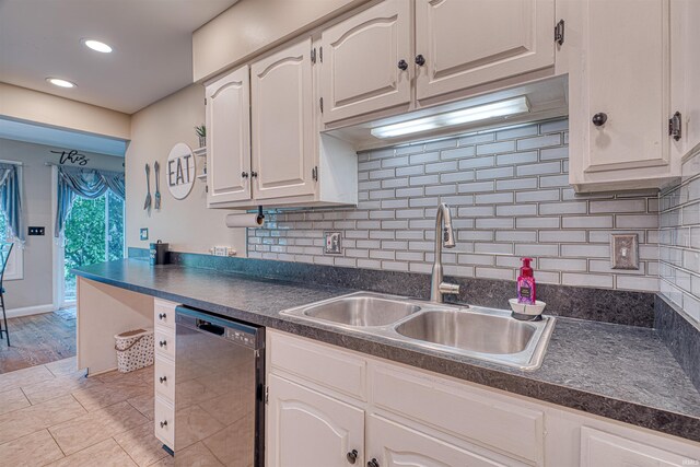 10711 Williamsburg Dr, Newburgh, IN 47630 - kitchen featuring black dishwasher, a sink, dark countertops, decorative backsplash, and recessed lighting