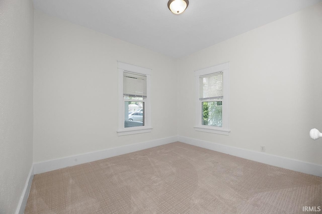 carpeted spare room with baseboards