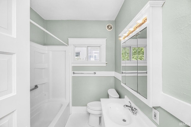 full bath featuring a sink, tile patterned flooring, shower / bathtub combination, and toilet