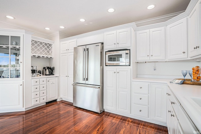 411 Auditorium Blvd, Winona Lake, IN 46590 - kitchen featuring high quality fridge, white microwave, dark wood finished floors, white cabinetry, and ornamental molding