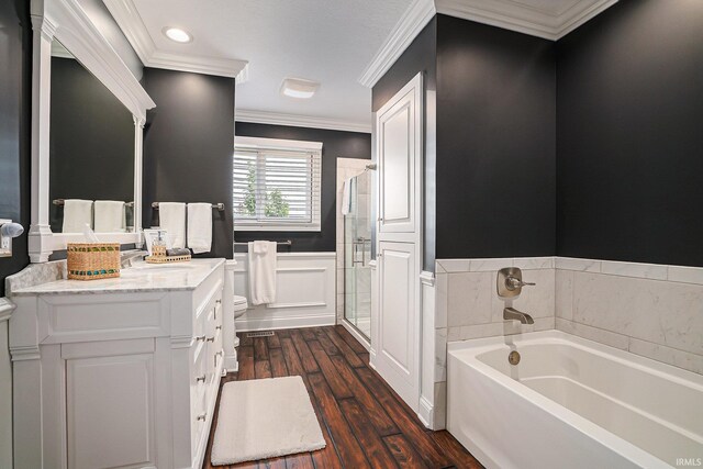 411 Auditorium Blvd, Winona Lake, IN 46590 - bathroom featuring wood finished floors, wainscoting, a garden tub, ornamental molding, and vanity