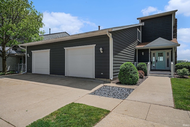 411 Auditorium Blvd, Winona Lake, IN 46590 - view of front facade with a garage and driveway
