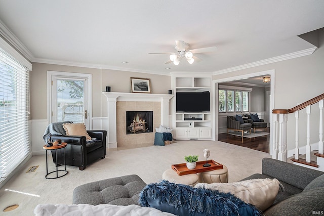 411 Auditorium Blvd, Winona Lake, IN 46590 - living area featuring ornamental molding, stairway, healthy amount of natural light, a ceiling fan, and carpet