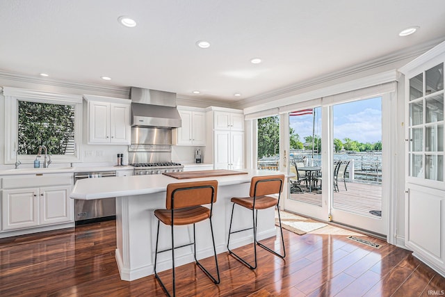 411 Auditorium Blvd, Winona Lake, IN 46590 - kitchen with stainless steel dishwasher, wall chimney range hood, a sink, stove, and light countertops