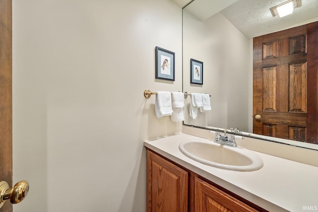 bathroom featuring vanity and a textured ceiling