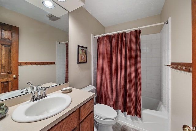 bathroom with toilet, shower / bath combo with shower curtain, and vanity