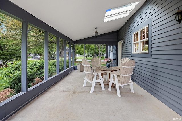 sunroom / solarium with a skylight and lofted ceiling