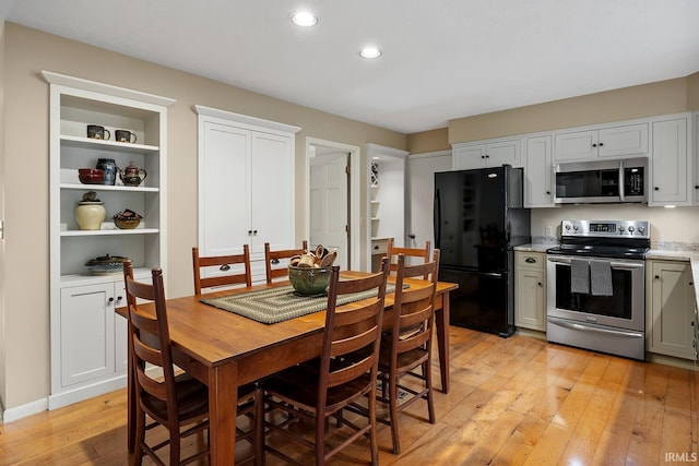 dining area featuring light wood-style flooring and recessed lighting