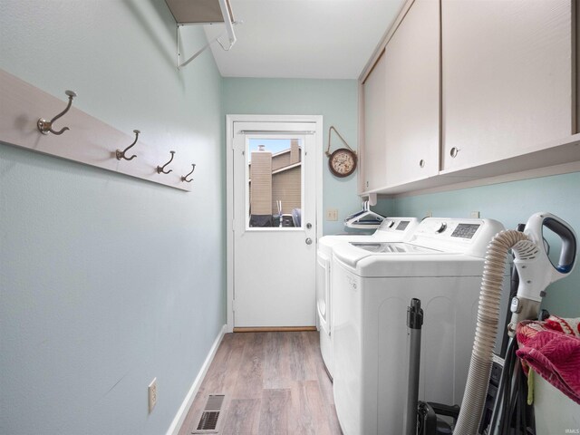 4904 Live Oak Ct, Fort Wayne, IN 46804 - laundry area with cabinet space, washing machine and clothes dryer, light wood finished floors, and baseboards