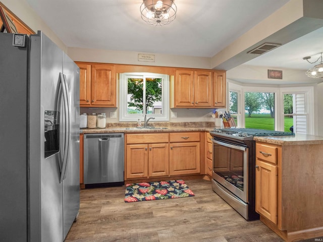 4904 Live Oak Ct, Fort Wayne, IN 46804 - kitchen with stainless steel appliances, a sink, a peninsula, and healthy amount of natural light