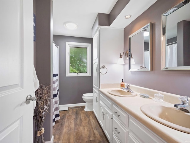 4904 Live Oak Ct, Fort Wayne, IN 46804 - bathroom featuring toilet, double vanity, wood finished floors, and baseboards