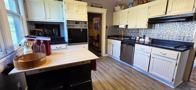 718 N Cherry St, Mount Carmel, IL 62439 - kitchen with black appliances, under cabinet range hood, a sink, backsplash, and wood finished floors