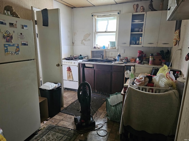 1211 N St, Logansport, IN 46947 - kitchen featuring white appliances, a sink, light countertops, and a paneled ceiling