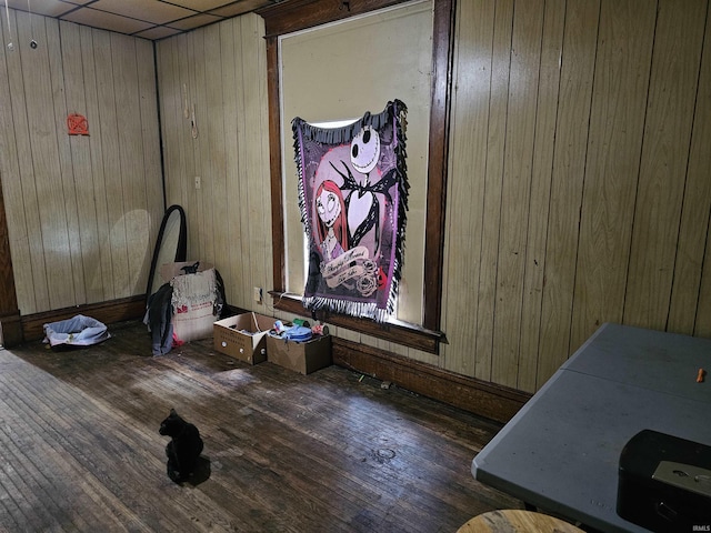 1211 N St, Logansport, IN 46947 - unfurnished bedroom featuring wood walls, wood finished floors, and baseboards