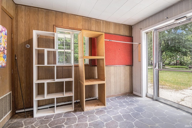 19401 Burke St, South Bend, IN 46637 - interior space featuring wood walls, stone floors, healthy amount of natural light, and baseboards
