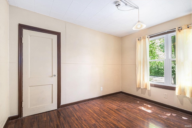 19401 Burke St, South Bend, IN 46637 - spare room featuring dark wood-style flooring and baseboards