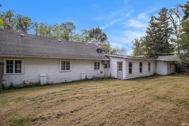 19401 Burke St, South Bend, IN 46637 - back of property featuring a yard, roof with shingles, and concrete block siding