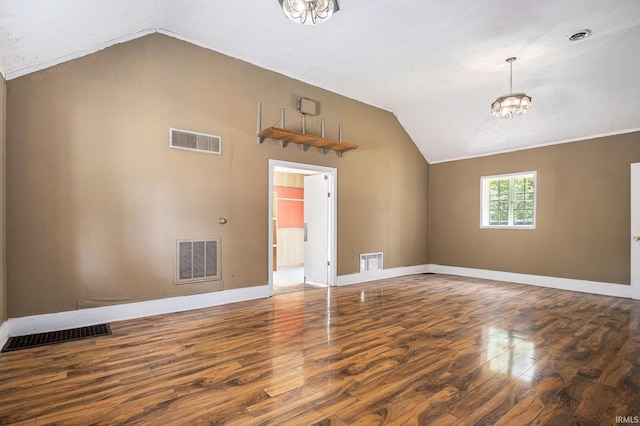 19401 Burke St, South Bend, IN 46637 - unfurnished living room featuring vaulted ceiling, wood finished floors, a chandelier, and baseboards
