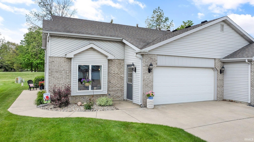 1725 E Inverness Cir, Columbia City, IN 46725 - view of front of home with brick siding, an attached garage, driveway, and a shingled roof