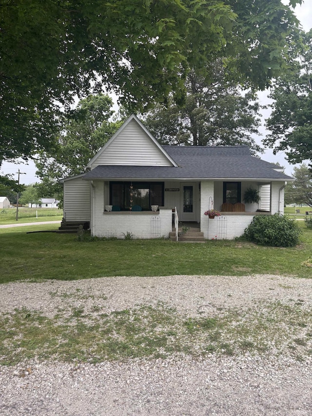 504 N Myra St, Worthington, IN 47471 - view of front of property with a porch, a front lawn, and brick siding