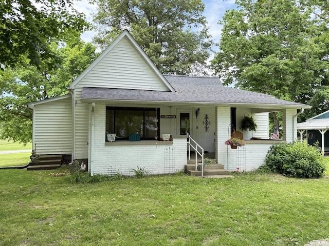 504 N Myra St, Worthington, IN 47471 - bungalow-style home with brick siding, a front yard, a porch, and roof with shingles