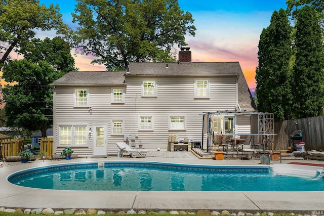 view of pool with fence and a deck