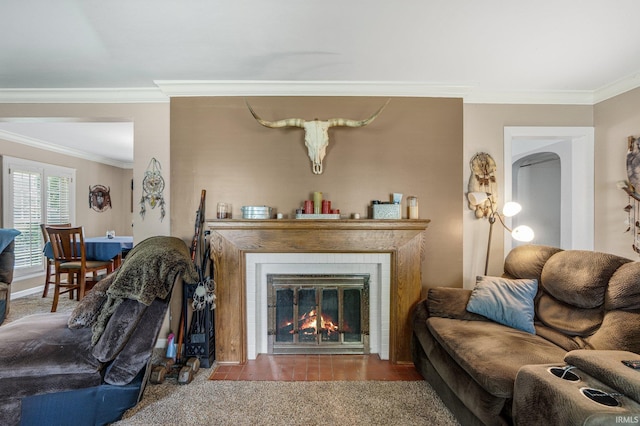 living room featuring crown molding and a fireplace with flush hearth