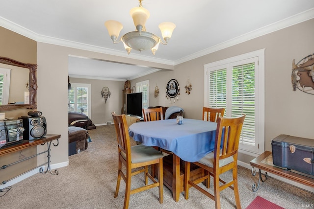 carpeted dining space with a chandelier, ornamental molding, and baseboards