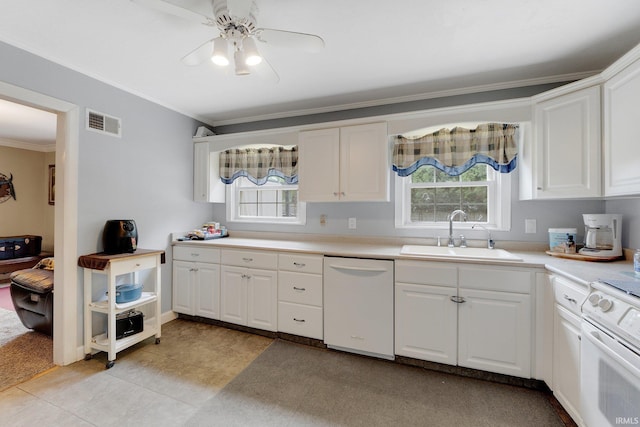 kitchen with white appliances, a sink, ornamental molding, white cabinetry, and ceiling fan