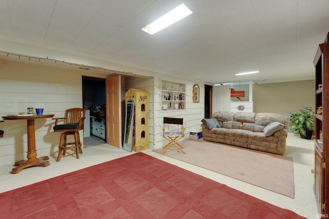 finished basement featuring carpet and ornamental molding