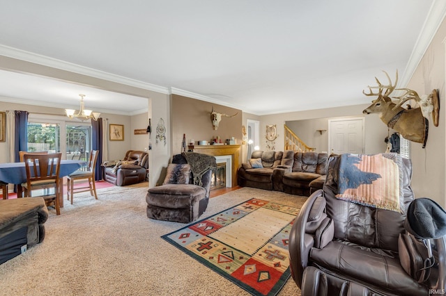 living room with a chandelier, ornamental molding, carpet, and a fireplace with flush hearth