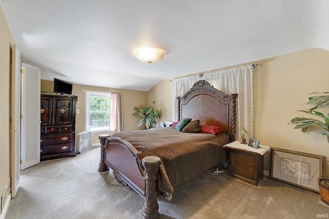 carpeted bedroom with lofted ceiling
