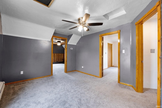217 S Hamsher St, Garrett, IN 46738 - additional living space with a ceiling fan, carpet, baseboards, a baseboard heating unit, and a textured ceiling