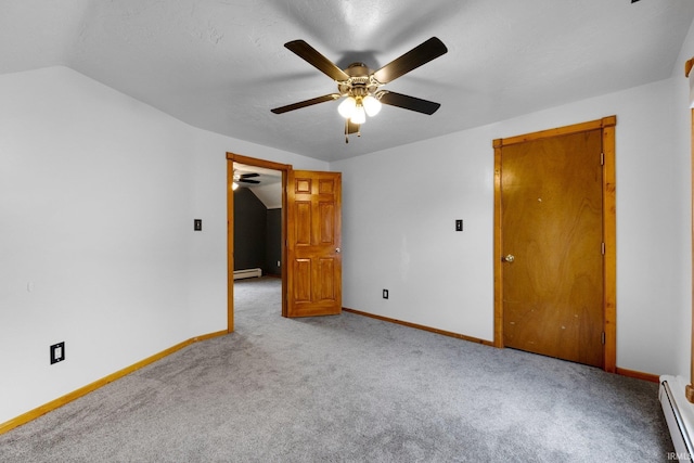 217 S Hamsher St, Garrett, IN 46738 - unfurnished bedroom with baseboard heating, carpet flooring, baseboards, and vaulted ceiling
