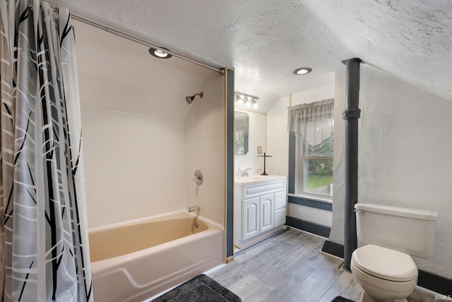 217 S Hamsher St, Garrett, IN 46738 - full bath featuring wood finished floors, vaulted ceiling, shower / bathtub combination with curtain, vanity, and toilet