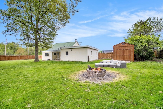 1652 N Sheridan St, South Bend, IN 46628 - back of house featuring a storage shed, an outdoor living space with a fire pit, an outdoor structure, and a chimney