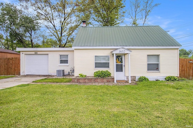 1652 N Sheridan St, South Bend, IN 46628 - view of front of home featuring central AC unit, a garage, concrete driveway, and metal roof