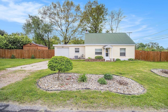 1652 N Sheridan St, South Bend, IN 46628 - view of front of property with an attached garage, cooling unit, metal roof, and a chimney