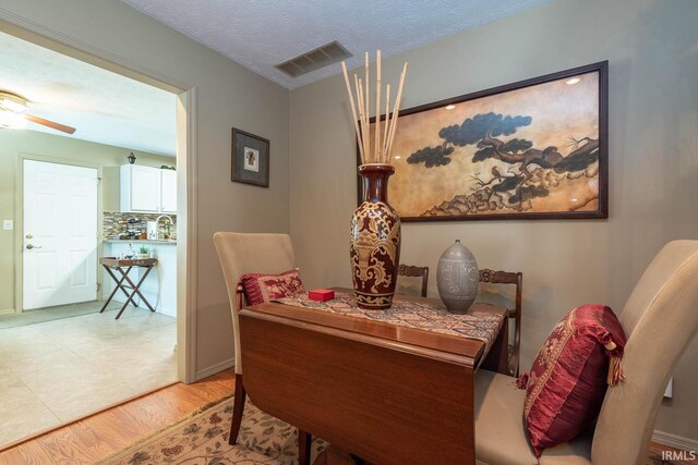 682 E Heather Dr, Bloomington, IN 47401 - dining room featuring a ceiling fan, light wood finished floors, and baseboards