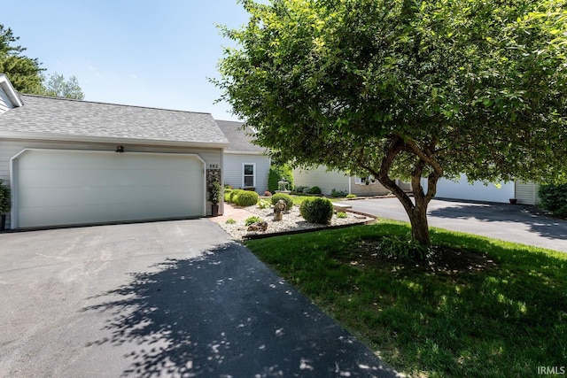 682 E Heather Dr, Bloomington, IN 47401 - view of front of property with a shingled roof, driveway, and an attached garage