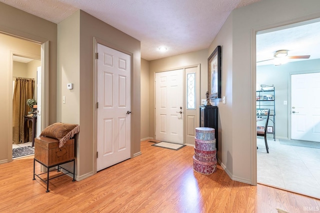 682 E Heather Dr, Bloomington, IN 47401 - foyer with light wood-style flooring, ceiling fan, and baseboards